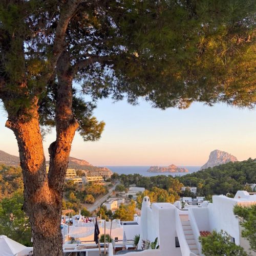 Sunset view from a cliff near Ibiza Old Town with a view of Es Vedra in the background.