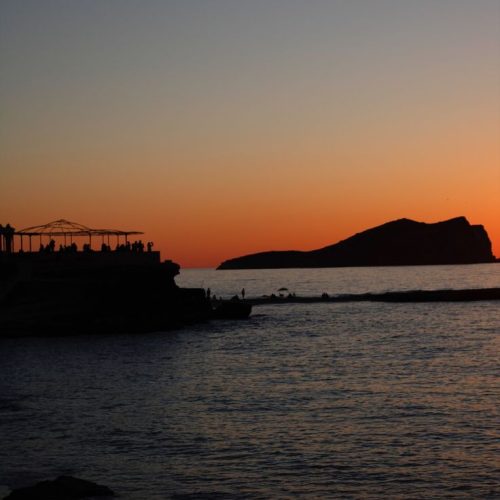 The sunset over the water in San Antonio with a view of Café del Mar