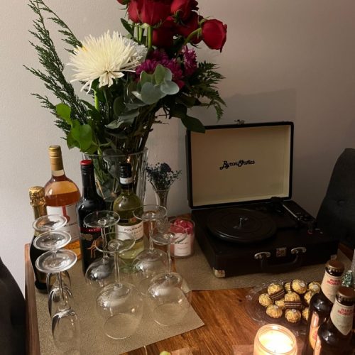 A drinks set up with flowers and a record player