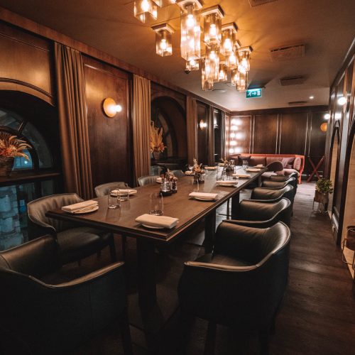 The Private dining room at Piazza Italian, set up in dim atmospheric lighting