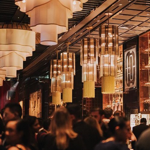 A busy bar with chandeliers at 1920 Dubai