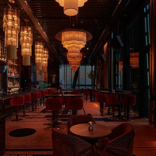 1920 Dubai dining room at night with glowing chandeliers