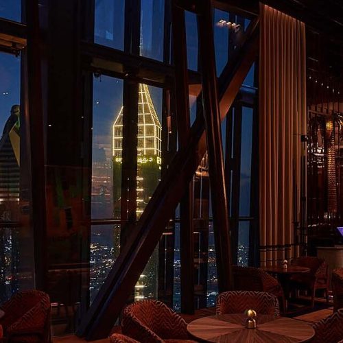 Outside of a window at 1920 Dubai with Dubai skyline in the background