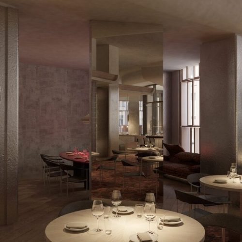The private dining room at Nela, with tables and chairs set up for guests