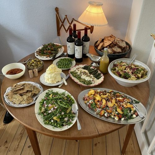A small table filled with food ready for a buffet style dinner party