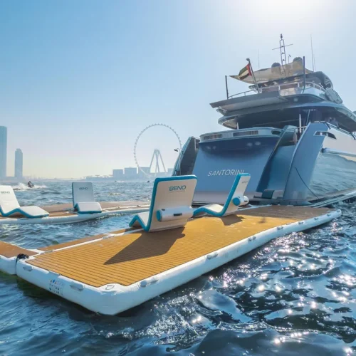 The exterior of a Beno Yachts, which has a sectioned of pool area in the sea with deckchairs surrounding