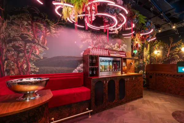The inside of the The Hide at Clays Soho, lit with neon lighting