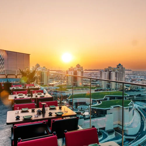 The balcony at sunset at Asia Asia The Palm with some tables laid up