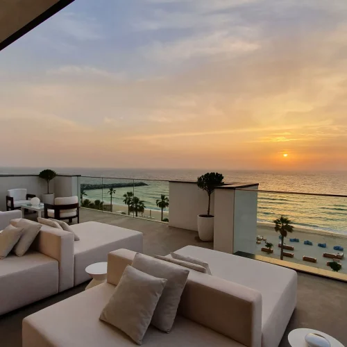 A view from a balcony at Nikki Beach, where the sun is setting across the sea