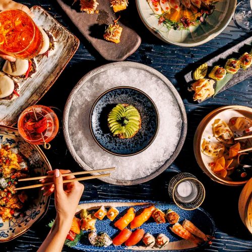 An aerial view of a table filled with sushi and chopsticks at Asia Asia The Palm