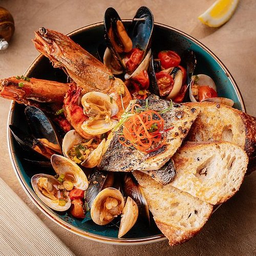 A seafood platter being served at Bla Bla Dubai with clams, muscles, prawns, and bread