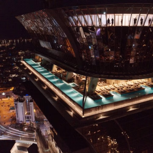 Aura Skypool from the outside of the building, with a view of the skypool that wraps around the building