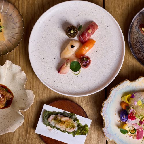 An aerial view of a table of food at Roketsu, including sushi and other Japanese dishes