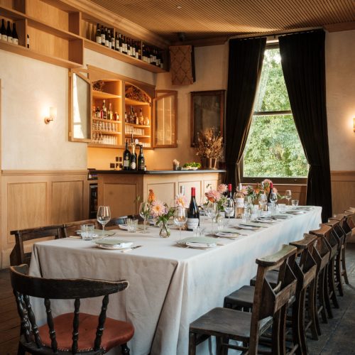 The private dining room at The Pelican, decorated simply with flowers on the table and low level lighting