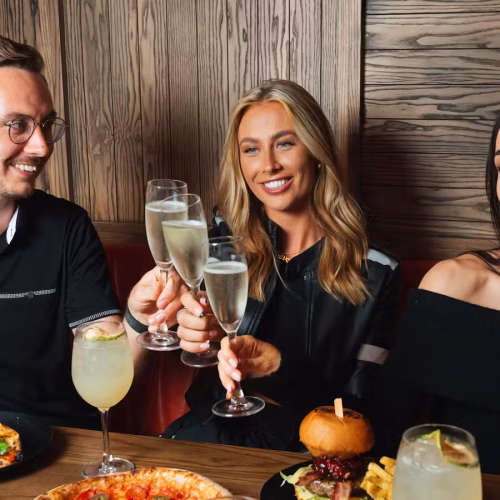 Guests cheering their champagne as they enjoy a celebration at Box Piccadilly