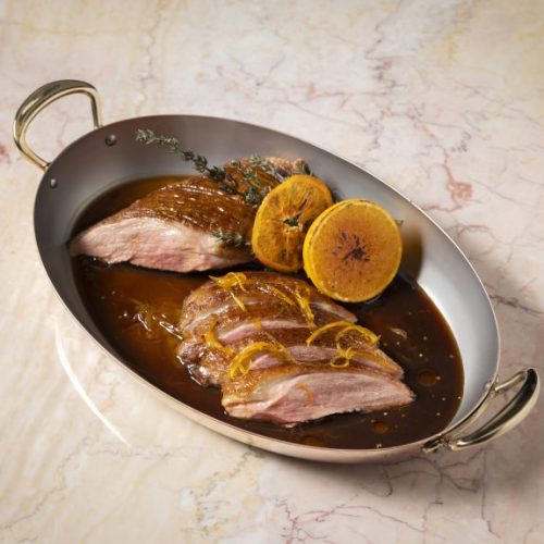 A plate of meat being served with a lemon at Rosi at The Beaumont