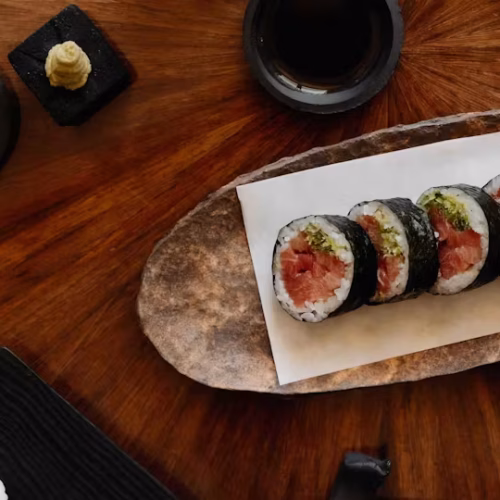 A wooden plate with sushi being served at Tobi Masa at The Chancery Rosewood