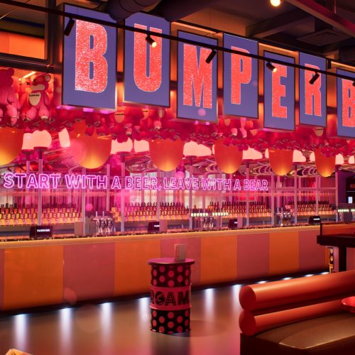 The bar at Fairgame the City, decorated with bright and neon colours