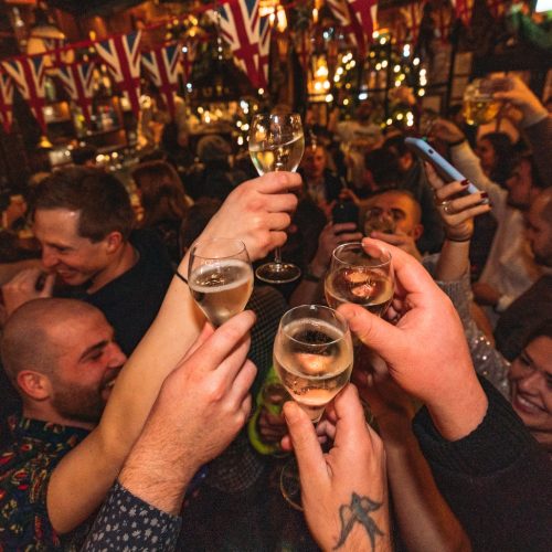 Friends cheersing their drinks as they welcome in the new year at Mr Fogg's