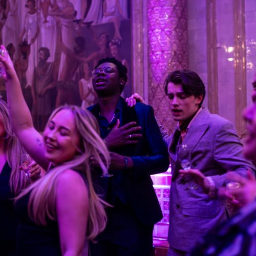 People enjoying a new years eve party together under purple lighting at One Whitehall Place