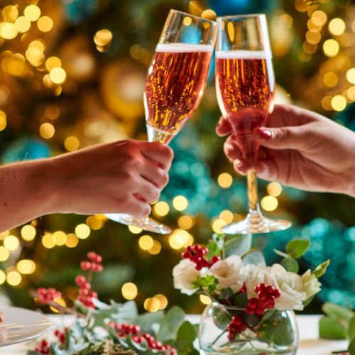 People cheering glasses of rose champagne over a new years eve dinner at The Landmark in London