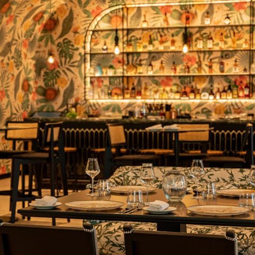 The bar and main restaurant area at the new Tresind, decorated with floral wallpaper and bright colours