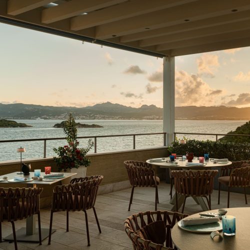The balcony at 7Pines Resort Sardinia, that overlooks the sea at sunset