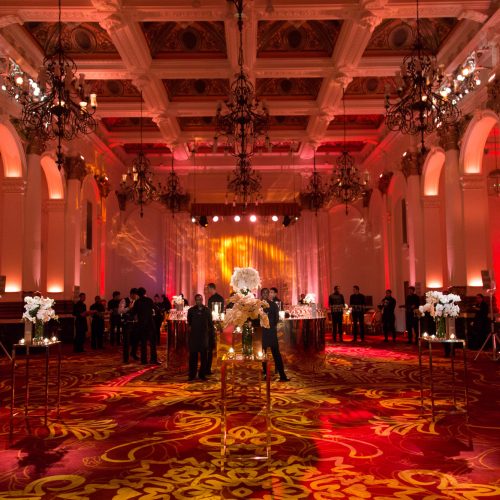 A large event set up at 8 Northumberland Avenue with red lights and a large standing space