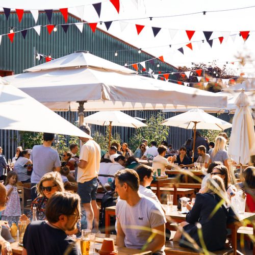 The outside space at Big Penny Social, which has umbrellas and bunting to decorate the space