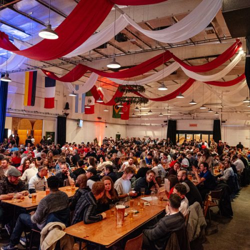 A large group of guests enjoying an event at Big Penny Social in their main event space