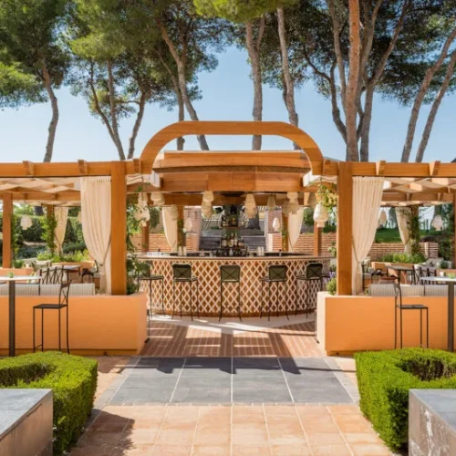 An outdoor event space and bar at Gran Marbella, decorated with bright terracotta colours and plenty of seating