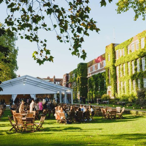 Guests enjoying an outdoor summer party at Regent’s Events, which has outside seating, and a marquee in the case of rain
