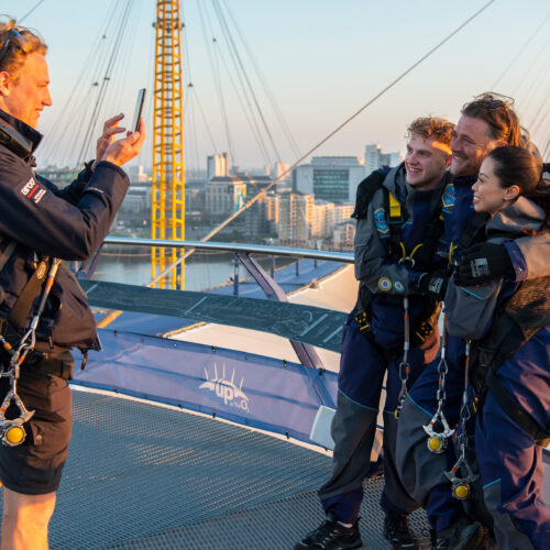 A group of friends getting a picture at the top of the O2 after climbing it with Up at The O2