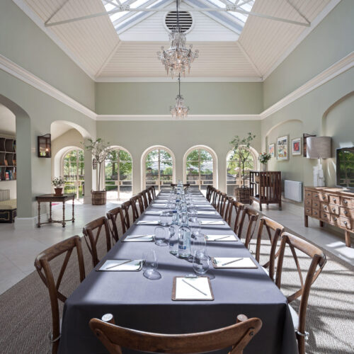 A large meeting room set up at Beaverbrook, in an event space filled with natural light and tall ceilings