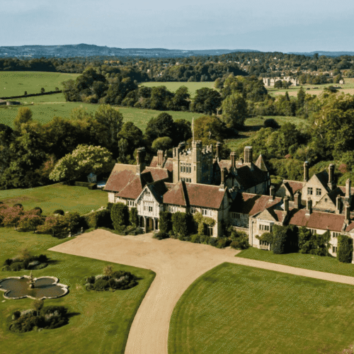 An aerial view of Cowdray House, surrounded by nature and trees