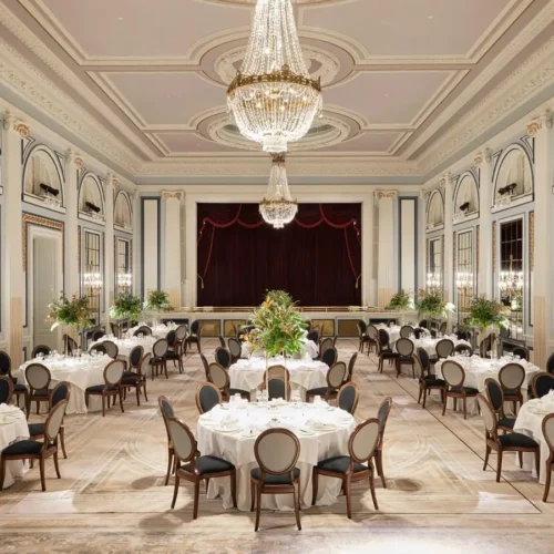 One of the main ballrooms at Gleneagles, decorated with a large chandelier and round tables