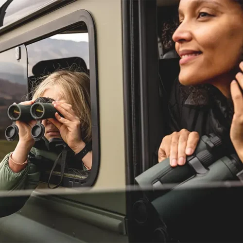 Guests using binoculars out of a 4by4 on a drive around the Gleneagles estate