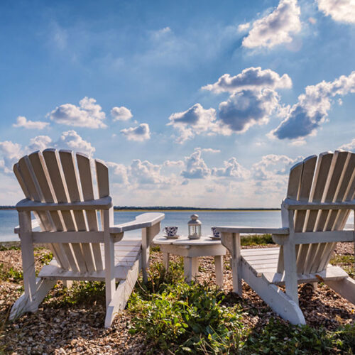 Two deck chairs looking out to the sea at Osea Island