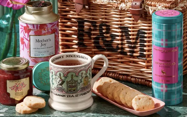 A Fortnum & Mason gift hamper, filled with biscuits, tea bags, and jams