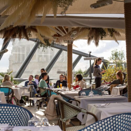 The inside area at Madison rooftop, with large windows that look over to the London skyling
