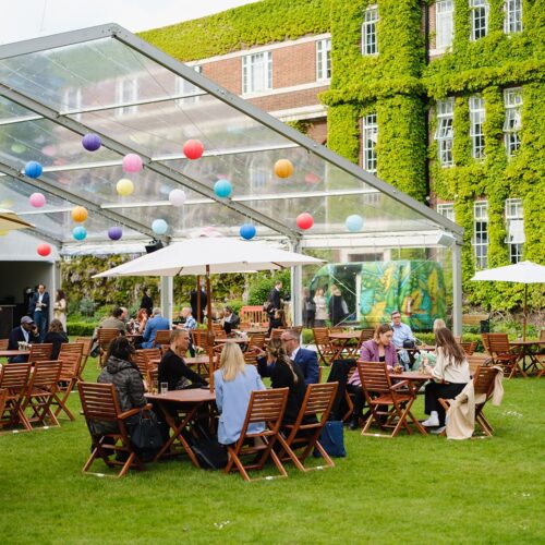 Guests enjoying the outdoor marquee for their summer party at Regent's Events