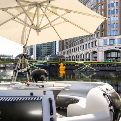 One of the Skuna Boats in the summer, set up with a BBQ and sun umberella