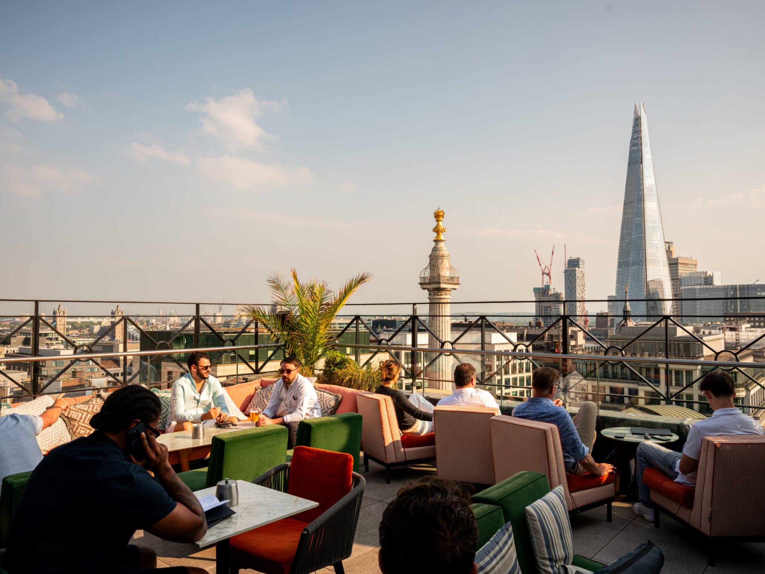 Guests enjoying casual drinks on Wagtail Rooftop with a clear view of the shard and comfortable seating
