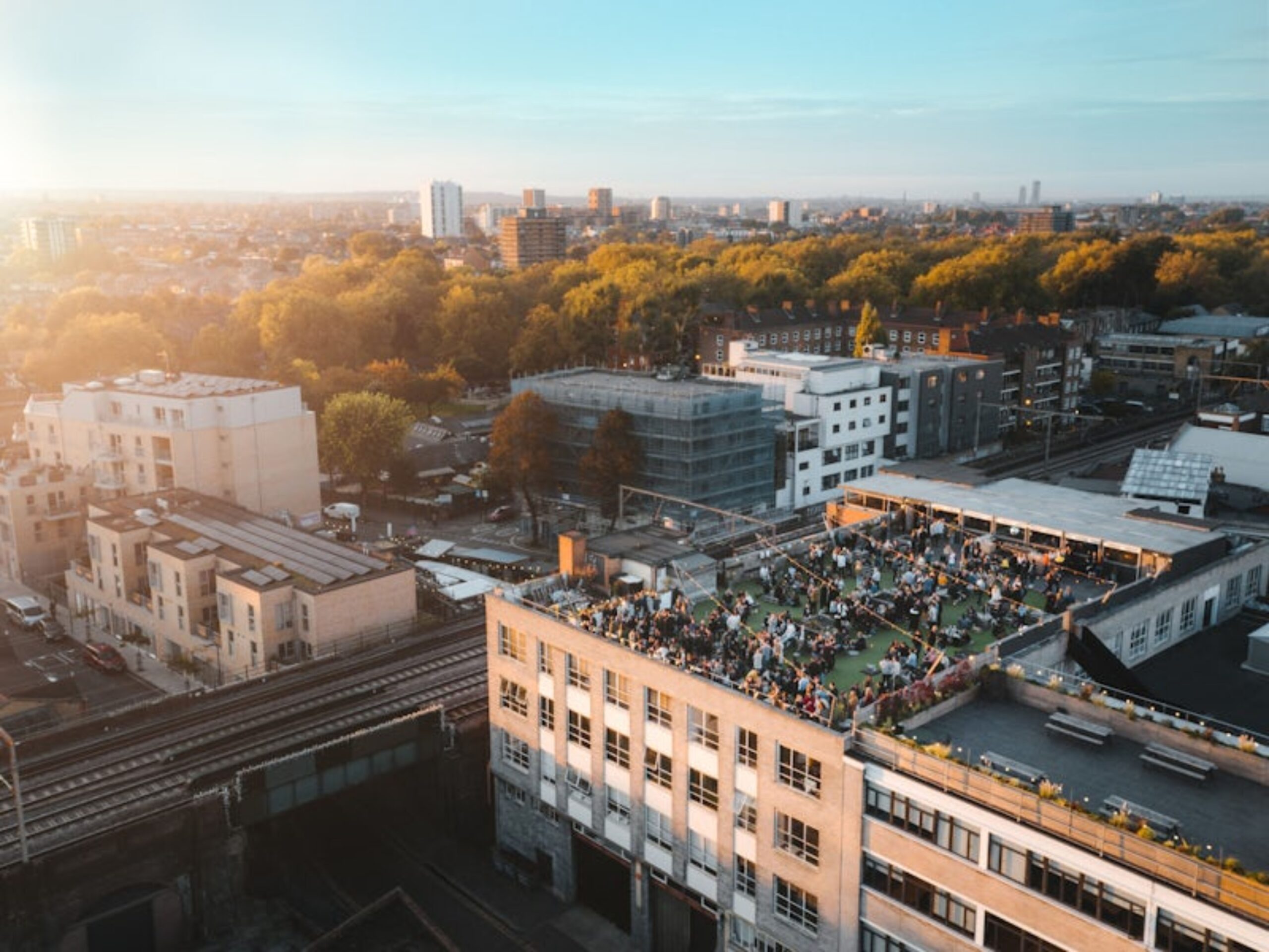 An aerial view of Netil360 at sunset, with a large open outdoor rooftop