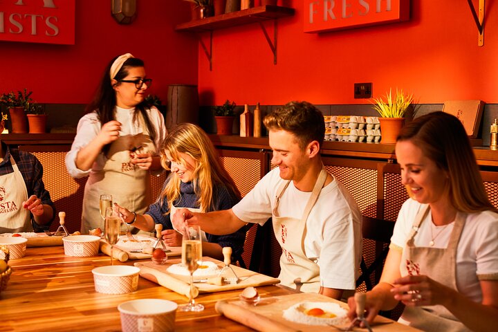 A team making pasta at a workshop at Pasta Evangelists, as a creative team building experience