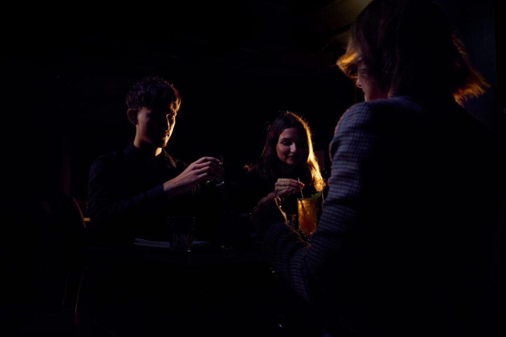 People experiencing a blind tasting, at the iconic Dans le Noir? which is in the pitch black