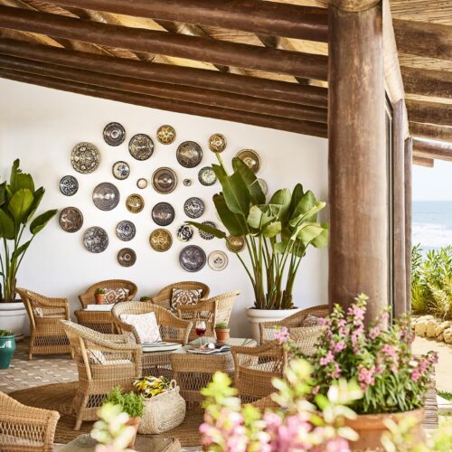 A private and cosy seating area in Marbella Club Hotel, decorated with rustic plates and greenery