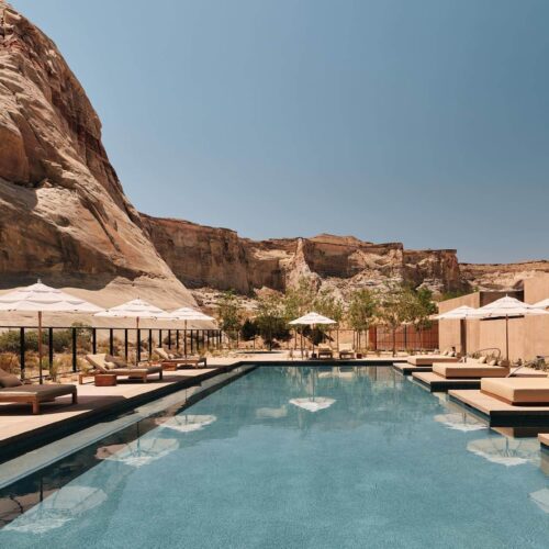 The main pool at Amangiri, surrounded by sun. loungers and umberellas