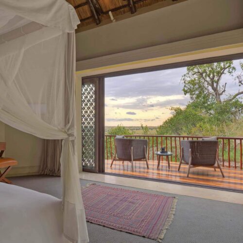 A large double room with large double doors that open onto a balcony at Four Seasons Safari Lodge Serengeti