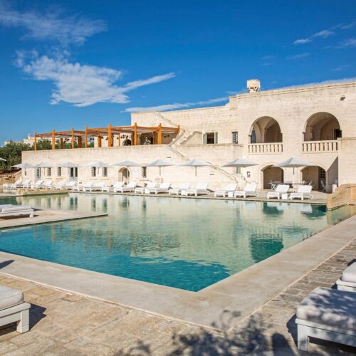 The main pool at Borgo Egnazia, surrounded by the stone hotel building